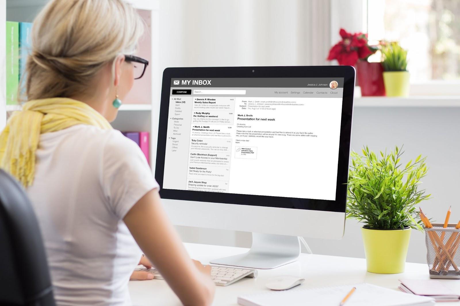 woman checking her email inbox on a desktop